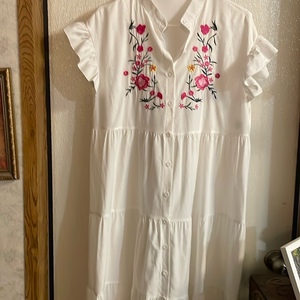 White dress with pink embroidery on the front. Size medium. Never worn